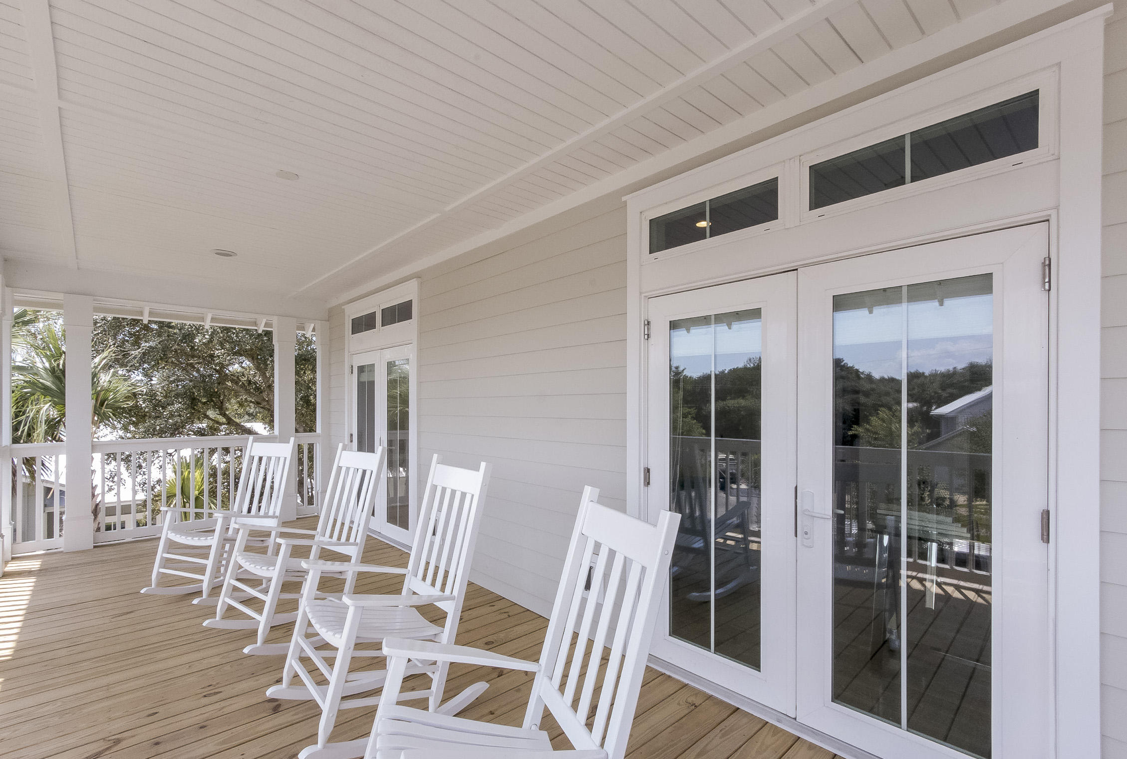 94 Blue Lake Road Santa Rosa Beach, FL 32459 - Photo 24 of 38 a view of dining room with wooden floor and outdoor seating