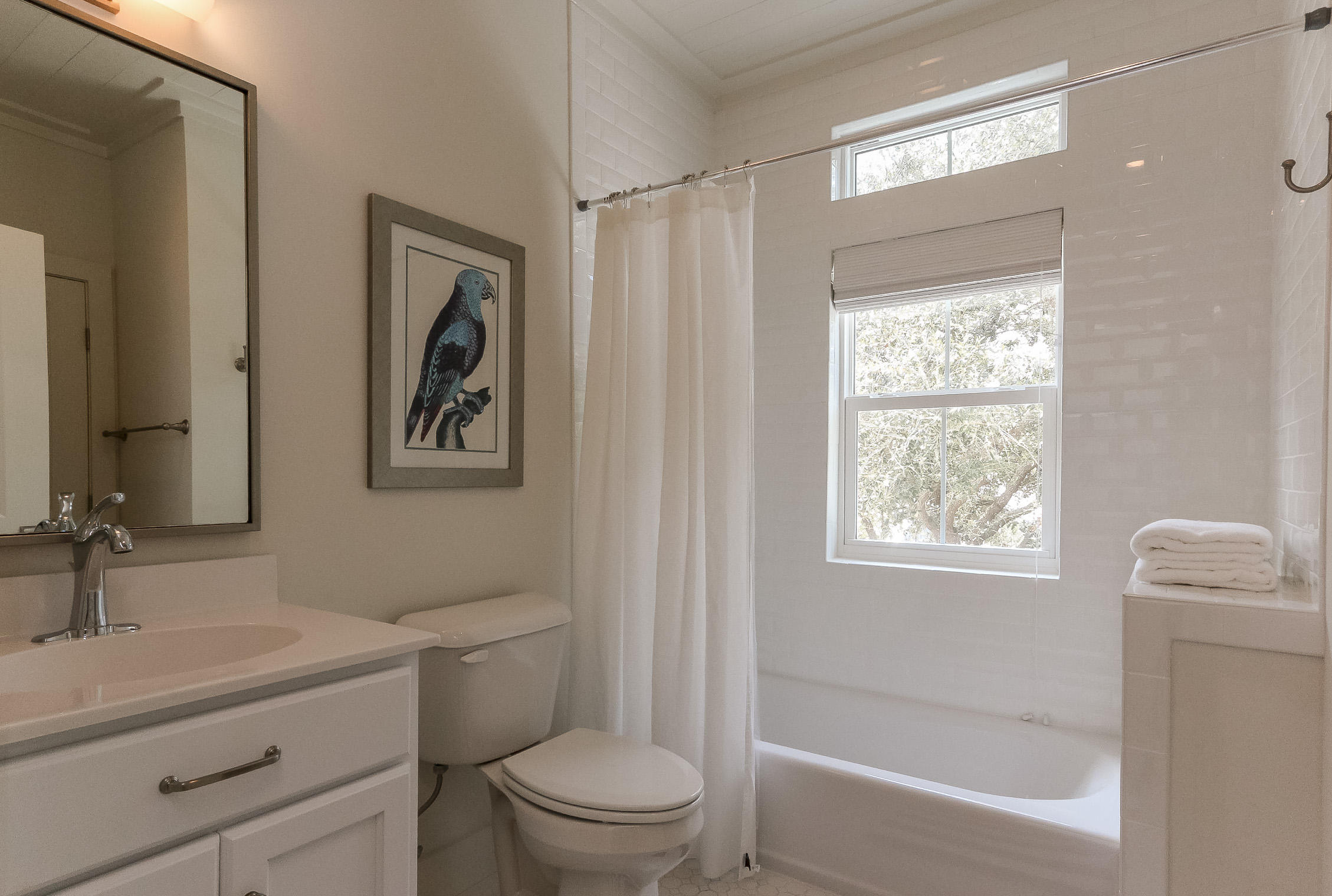 94 Blue Lake Road Santa Rosa Beach, FL 32459 - Photo 32 of 38 a bathroom with a toilet a sink a mirror a shower and vanity