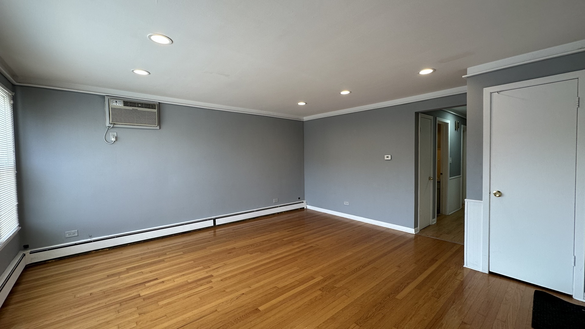 6118 West Gunnison Street, Unit 1 Chicago, IL 60630 - Photo 2 of 11 wooden floor in an empty room with a window