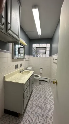 a view of empty room with a window and wooden floor