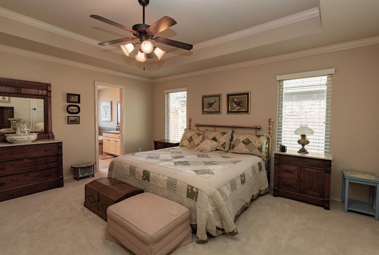 4110 124th Street Lubbock, TX 79423 - Photo 13 of 32 a spacious bedroom with a bed and a chandelier