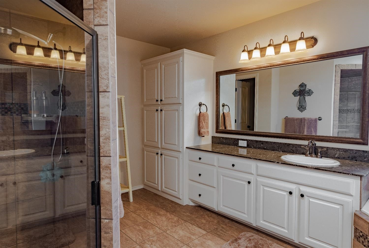 4110 124th Street Lubbock, TX 79423 - Photo 16 of 32 a bathroom with double sink and a mirror