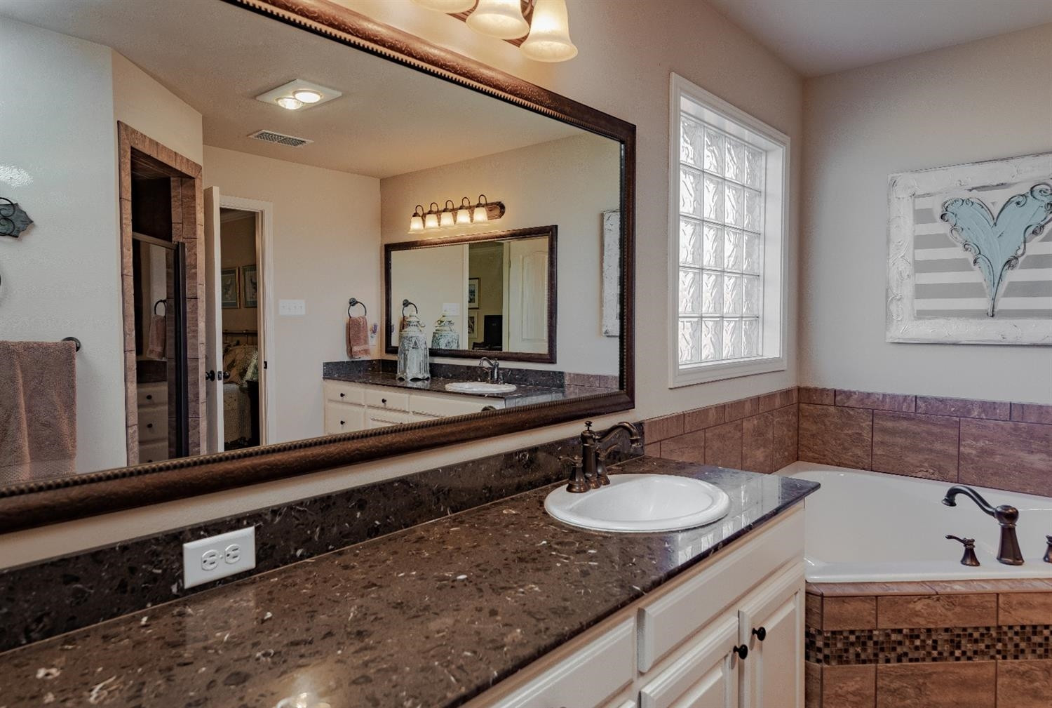 4110 124th Street Lubbock, TX 79423 - Photo 18 of 32 a bathroom with a sink double vanity granite and a mirror