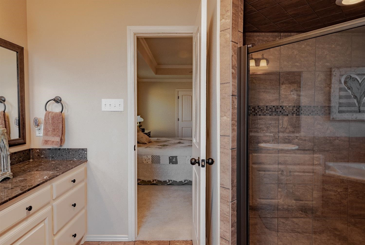 4110 124th Street Lubbock, TX 79423 - Photo 19 of 32 a en suite bathroom with a granite countertop sink and a mirror