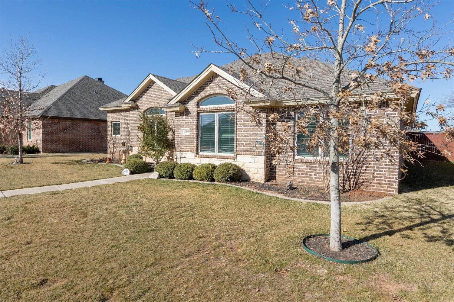 4110 124th Street Lubbock, TX 79423 - Photo 31 of 32 a front view of a house with a yard