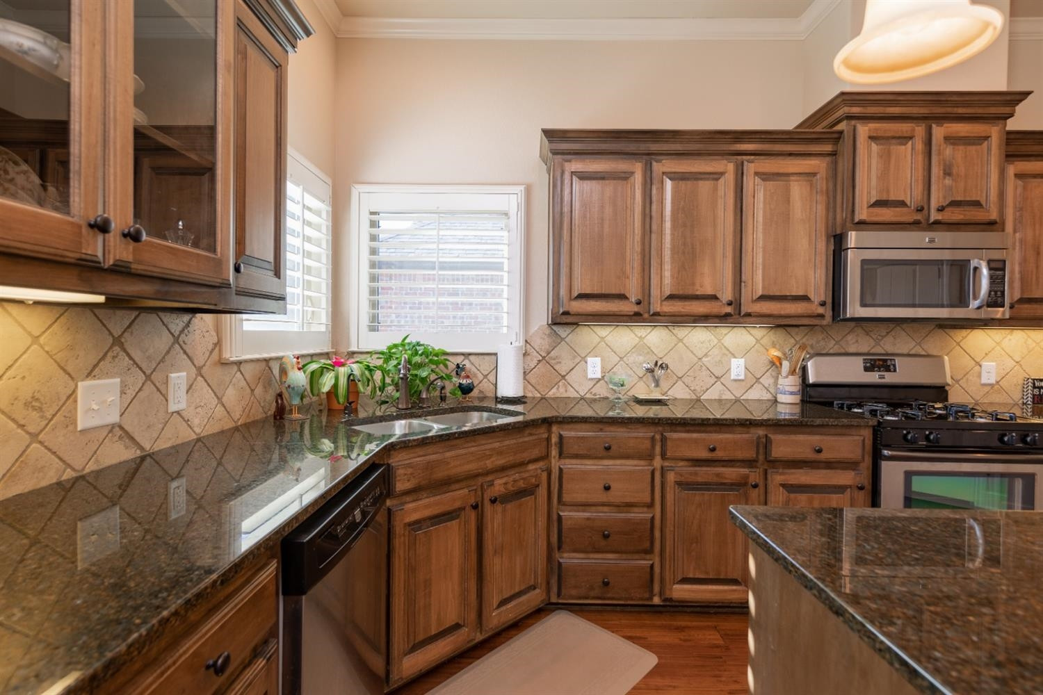 4110 124th Street Lubbock, TX 79423 - Photo 5 of 32 a kitchen with granite countertop a sink a stove and cabinets