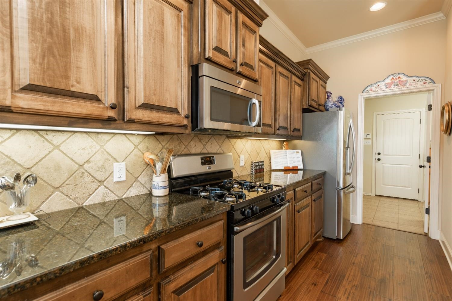 4110 124th Street Lubbock, TX 79423 - Photo 9 of 32 a kitchen with stainless steel appliances granite countertop a stove and a microwave
