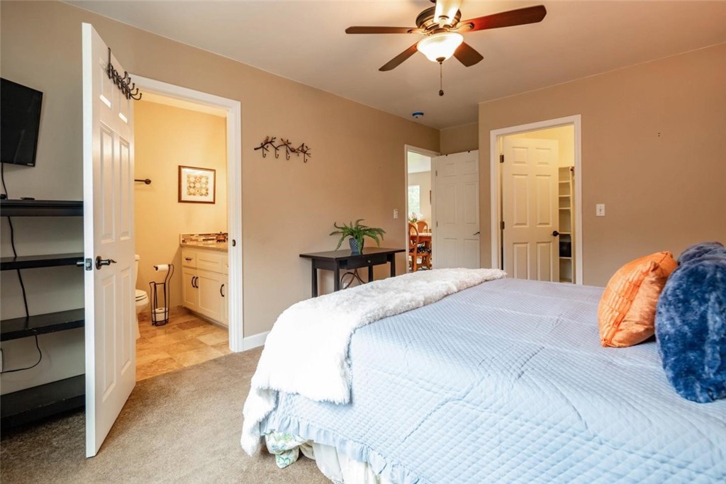 2138 Wilton Drive Cambria, CA 93428 - Photo 17 of 37 a bedroom with a bed and a chandelier