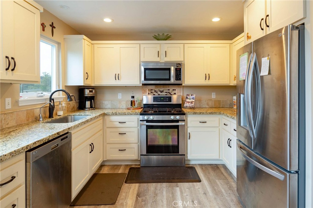 2138 Wilton Drive Cambria, CA 93428 - Photo 7 of 37 a kitchen with a refrigerator stove and sink