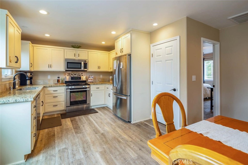 2138 Wilton Drive Cambria, CA 93428 - Photo 8 of 37 a kitchen with stainless steel appliances a stove a sink a refrigerator cabinets and a dining table