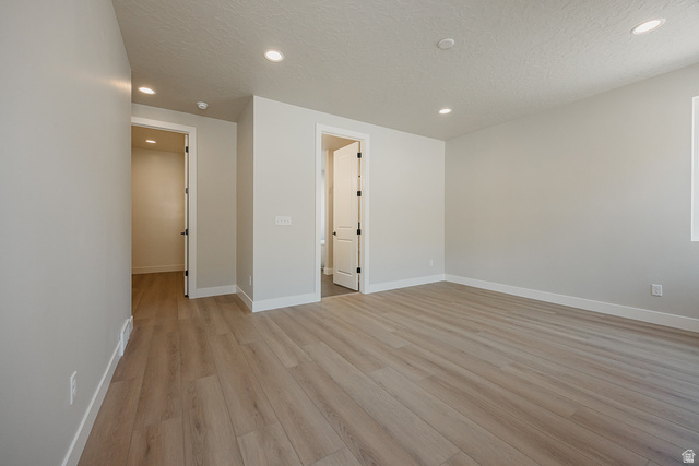 5910 Canyon Rim Road, Unit 619 Lehi, UT 84048 - Photo 26 of 52 Recessed lighting, light-toned wood-finish flooring, white walls, white trim, and interior doors with dark hardware