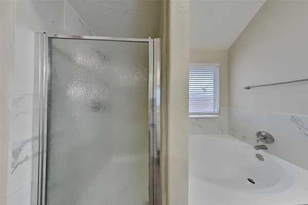 a bathroom with a bathtub and a shower