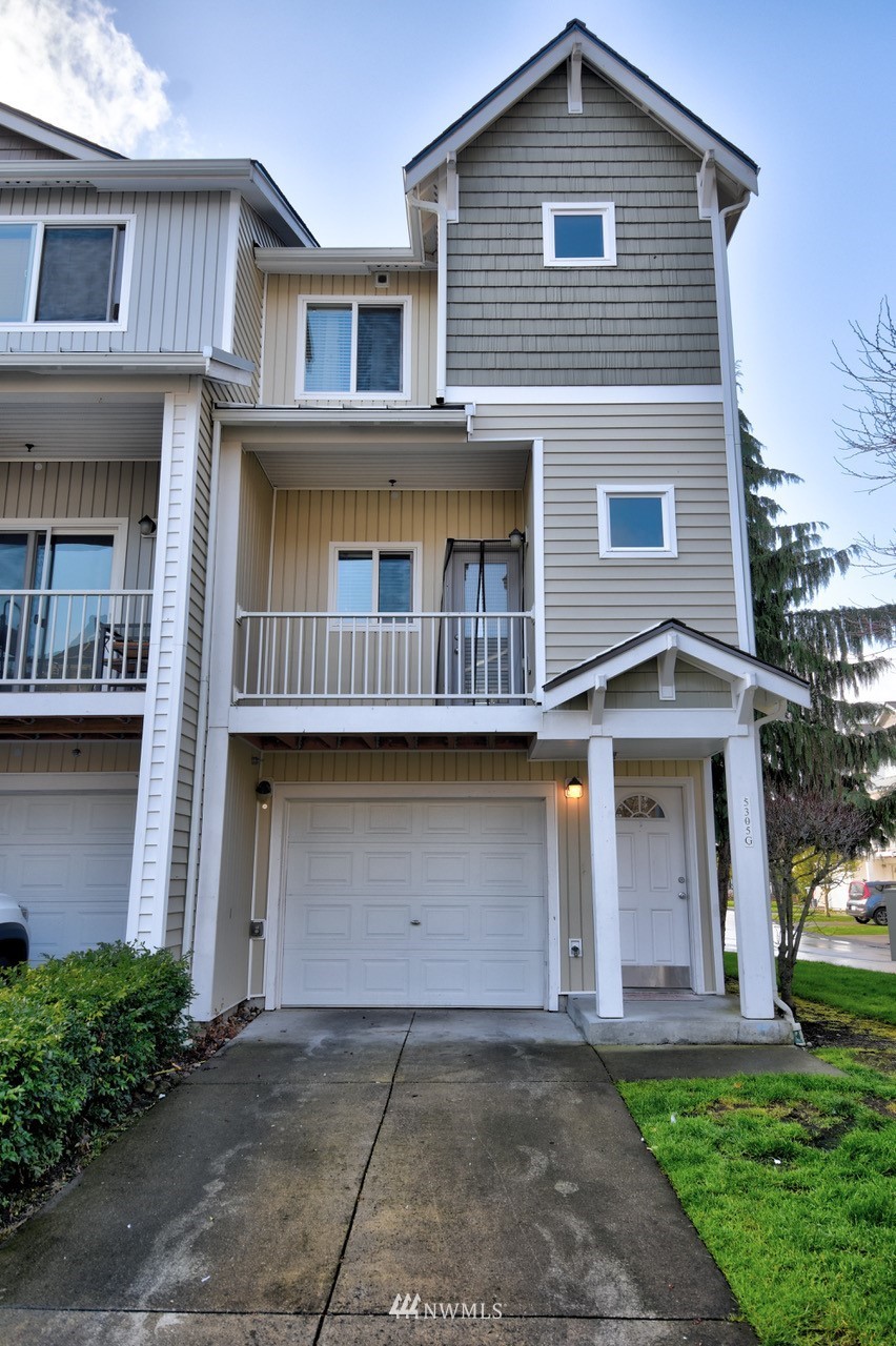 5305 Military Road East, Unit G Tacoma, WA 98446 - Photo 1 of 22 a front view of a house with a yard and garage