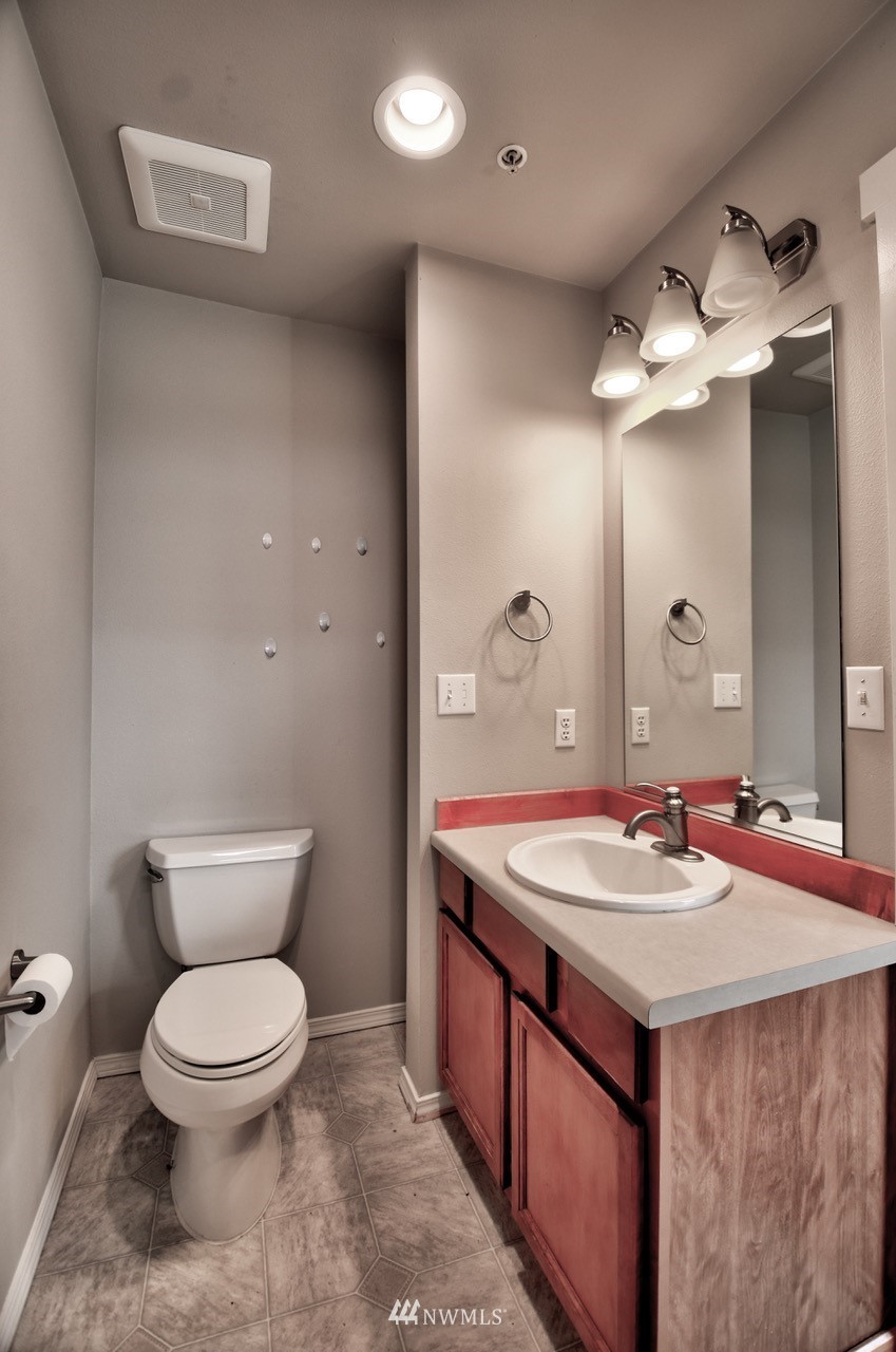 5305 Military Road East, Unit G Tacoma, WA 98446 - Photo 11 of 22 a bathroom with a sink and a mirror