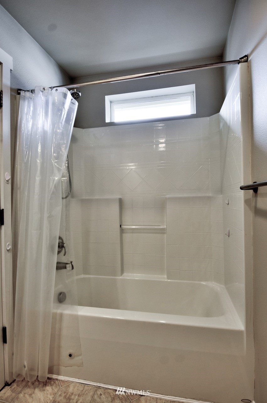 5305 Military Road East, Unit G Tacoma, WA 98446 - Photo 12 of 22 a bathroom with a shower and a bath tub