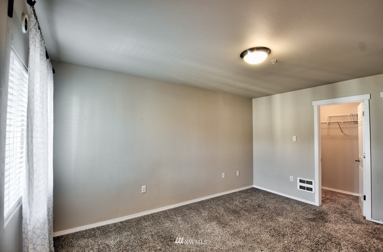 5305 Military Road East, Unit G Tacoma, WA 98446 - Photo 14 of 22 an empty room with closet and windows