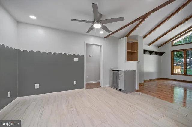 a view of a hallway with wooden floor and a sink
