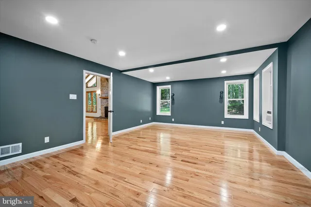 a bathroom with a granite countertop toilet a sink and a mirror