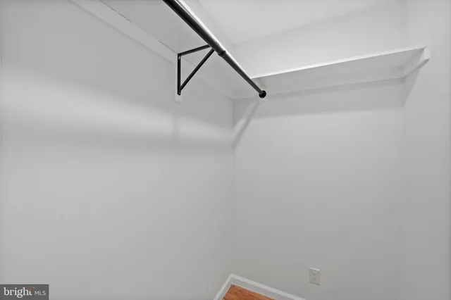 an empty room with a ceiling fan and a window