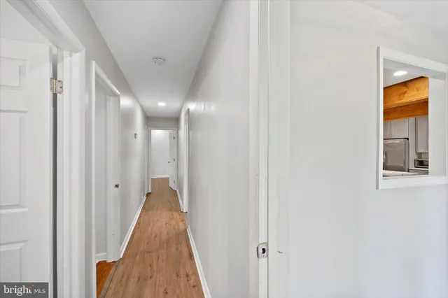 an empty room with ceiling fan and window