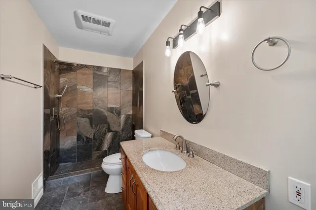 a kitchen with stainless steel appliances granite countertop wooden cabinets a sink and dishwasher