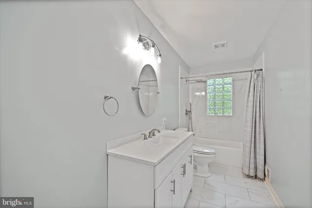 a kitchen with stainless steel appliances granite countertop a sink a stove cabinets counter space and a window