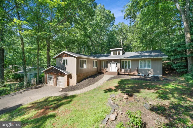 a living room with furniture a fireplace and a floor to ceiling window