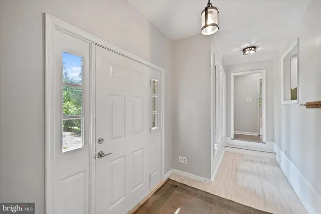 a view of empty room with wooden floor and fireplace