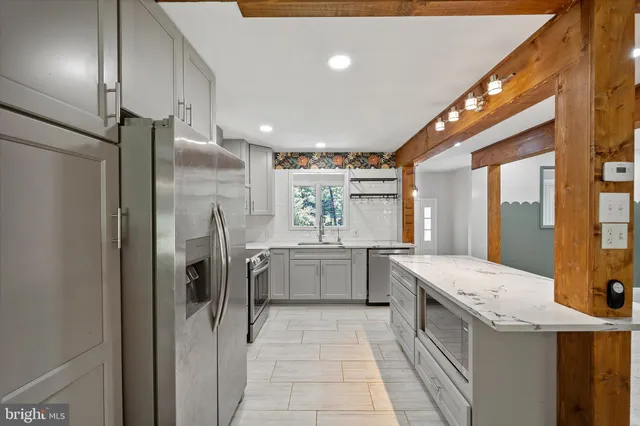 a view of empty room with a fireplace and windows