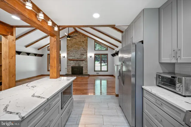 a kitchen with a sink stainless steel appliances and cabinets