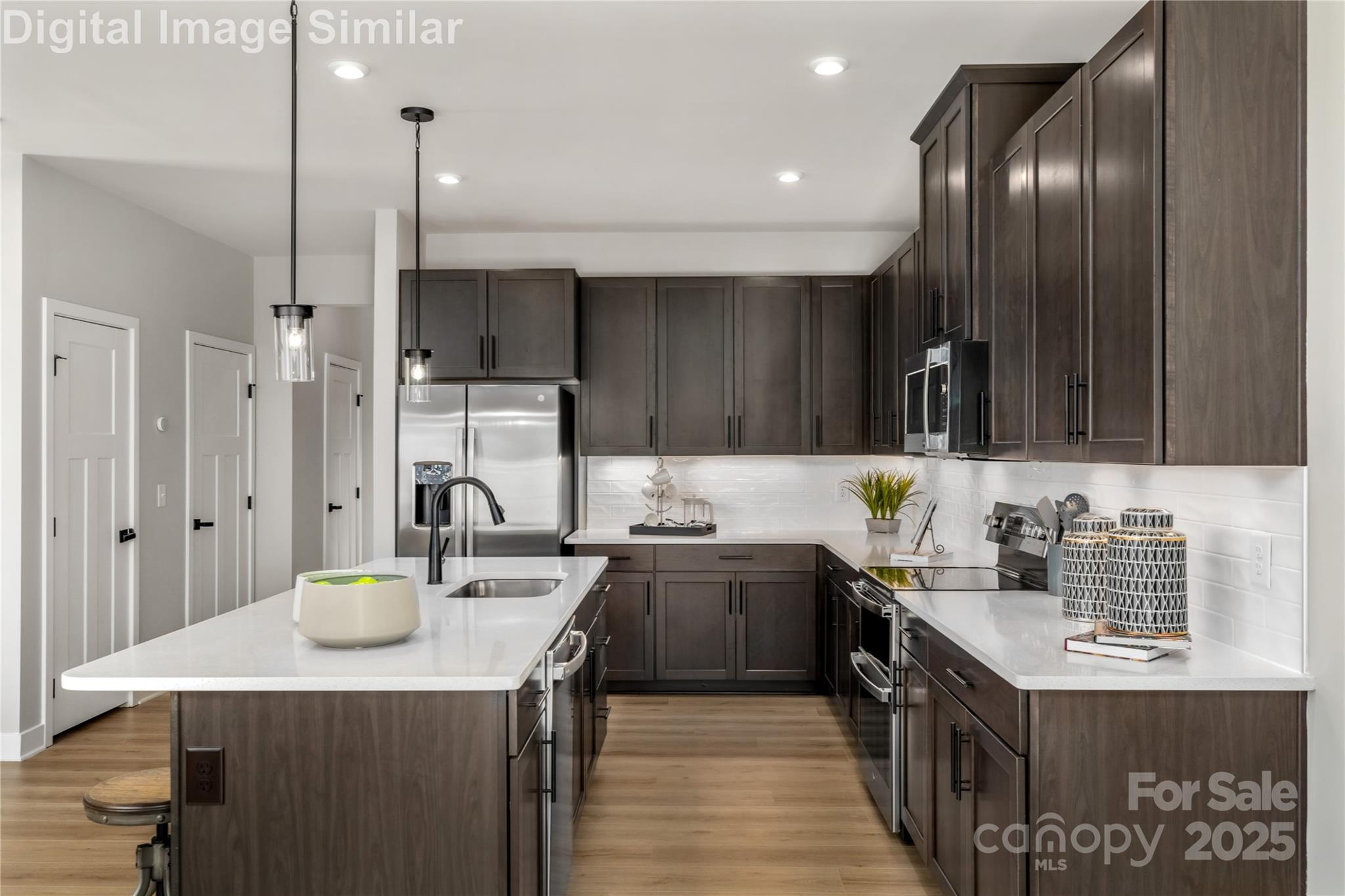 9551 Teamwork Street Northwest Concord, NC 28027 - Photo 4 of 23 a kitchen with sink cabinets and stainless steel appliances
