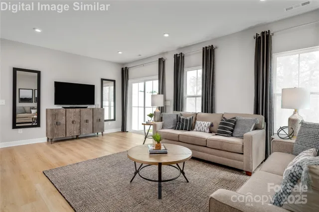 a living room with furniture and a flat screen tv