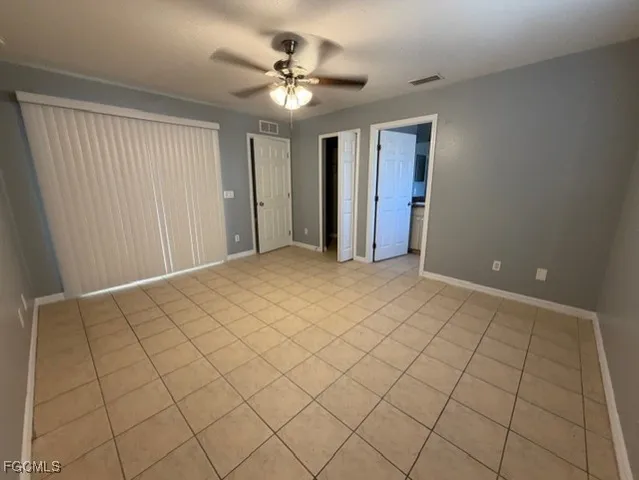 a view of a livingroom with an empty space and a ceiling fan