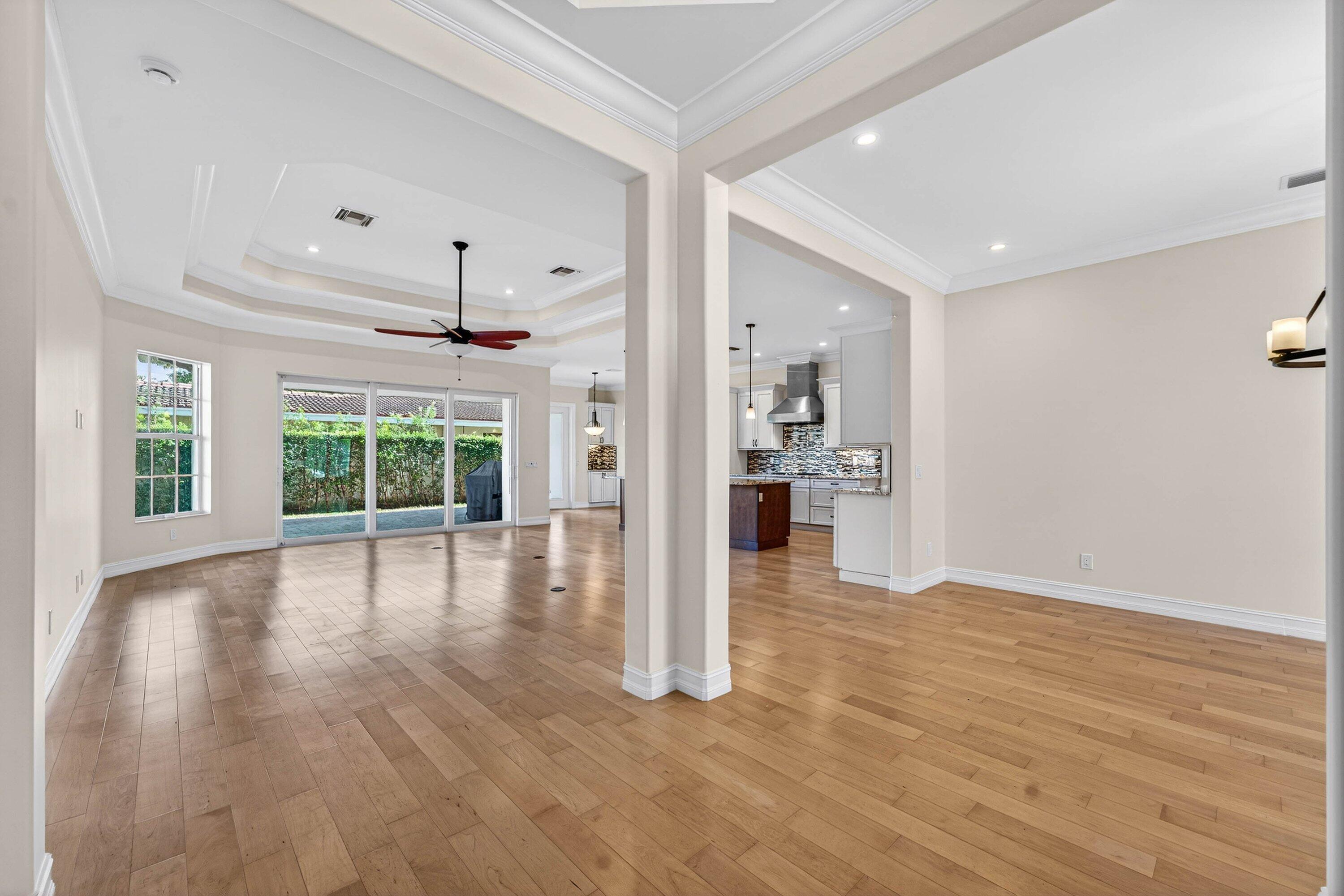 2920 Spanish River Road Boca Raton, FL 33432 - Photo 16 of 75 a view of an empty room with wooden floor and a kitchen