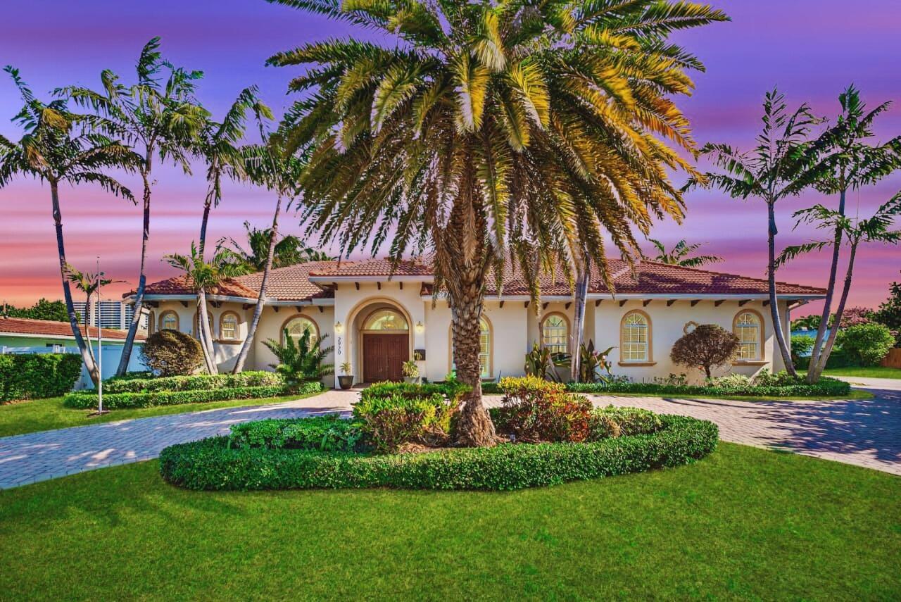 2920 Spanish River Road Boca Raton, FL 33432 - Photo 2 of 75 a front view of a house with a garden