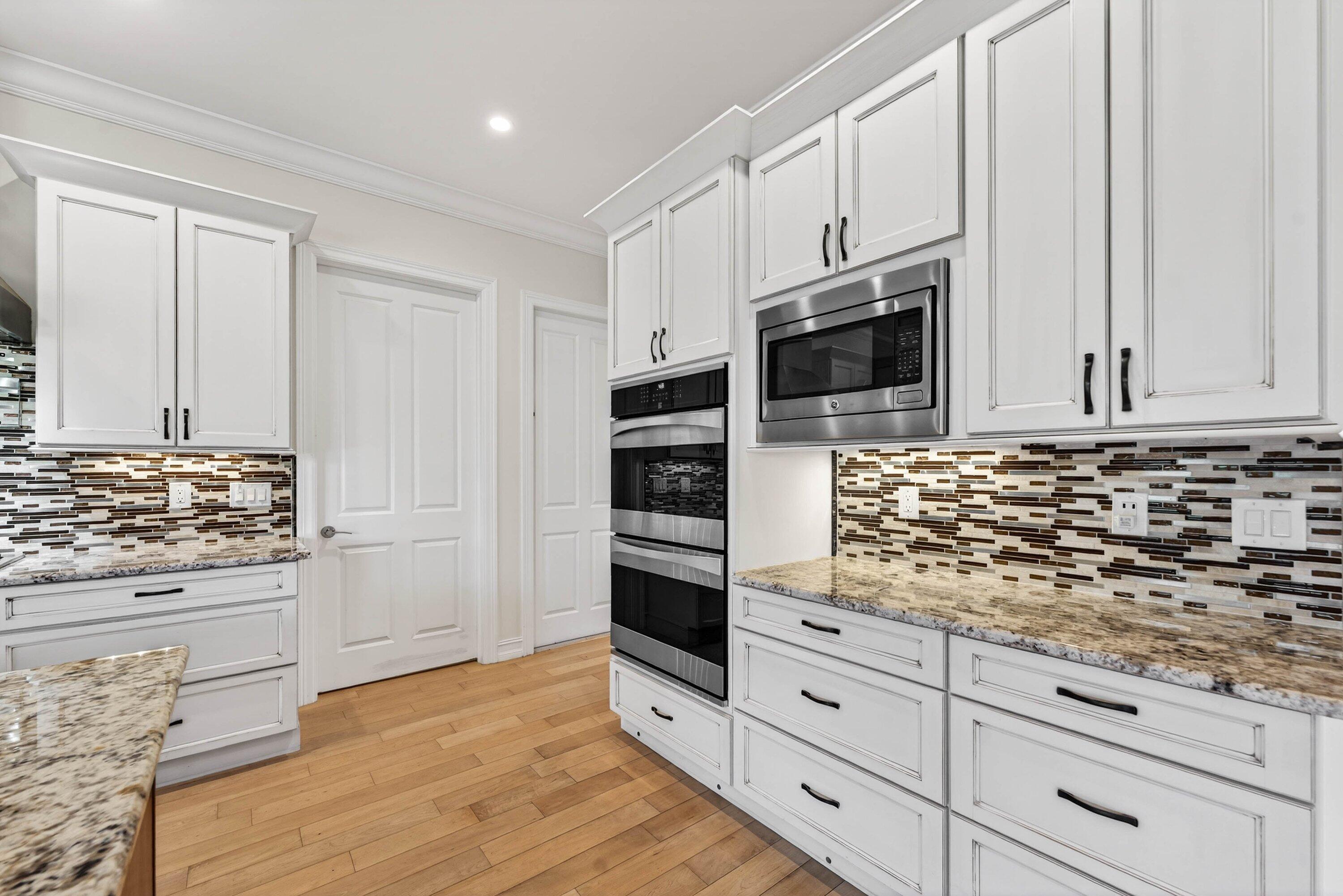 2920 Spanish River Road Boca Raton, FL 33432 - Photo 24 of 75 a kitchen with stainless steel appliances granite countertop a stove and a microwave