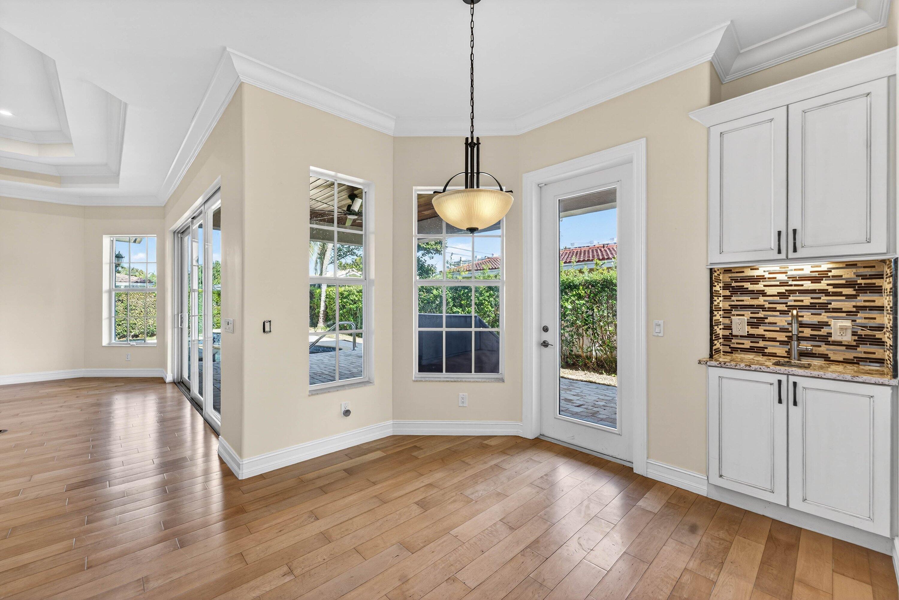 2920 Spanish River Road Boca Raton, FL 33432 - Photo 27 of 75 a view of an empty room with wooden floor and a window