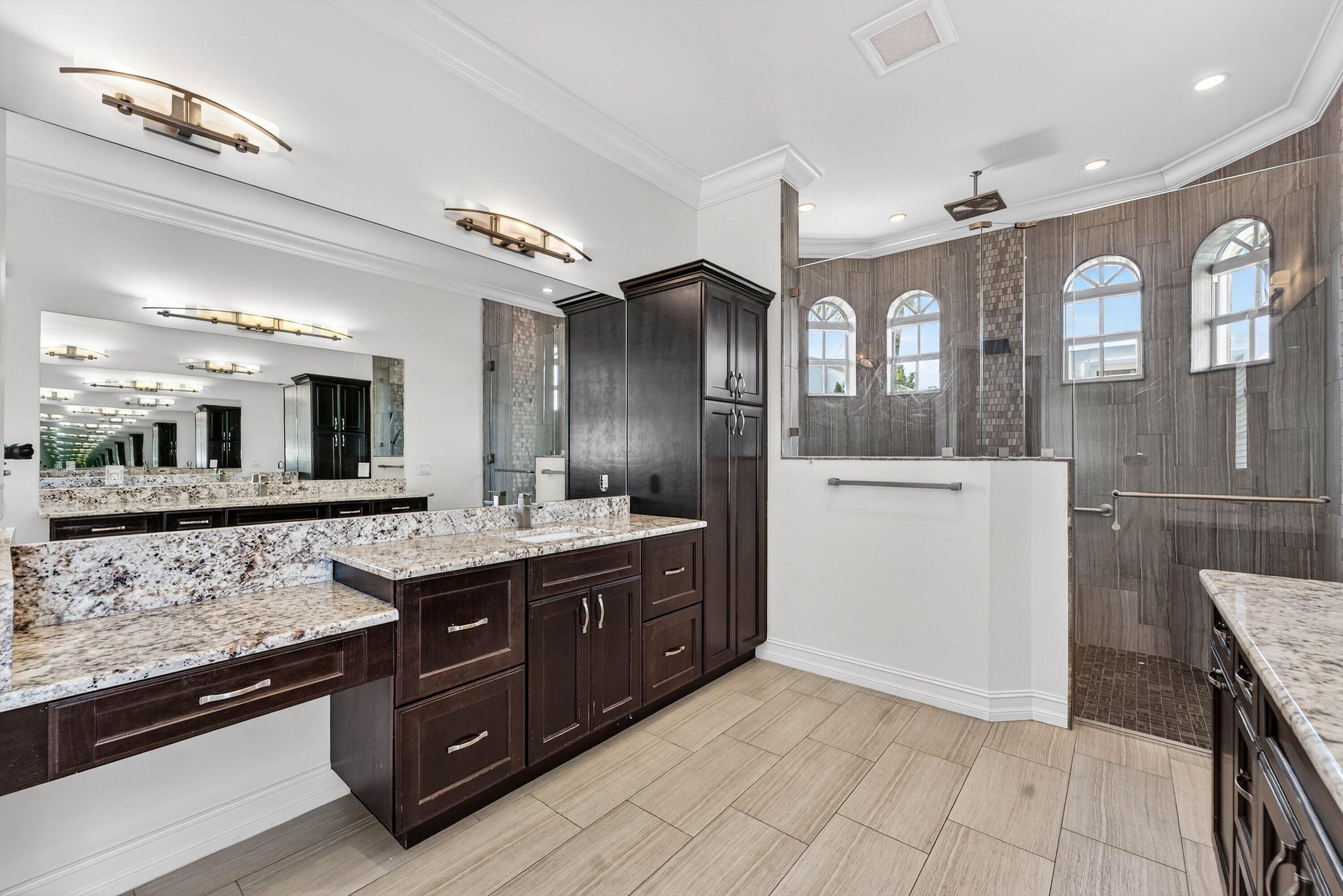 2920 Spanish River Road Boca Raton, FL 33432 - Photo 34 of 75 a spacious bathroom with a granite countertop sink and a mirror