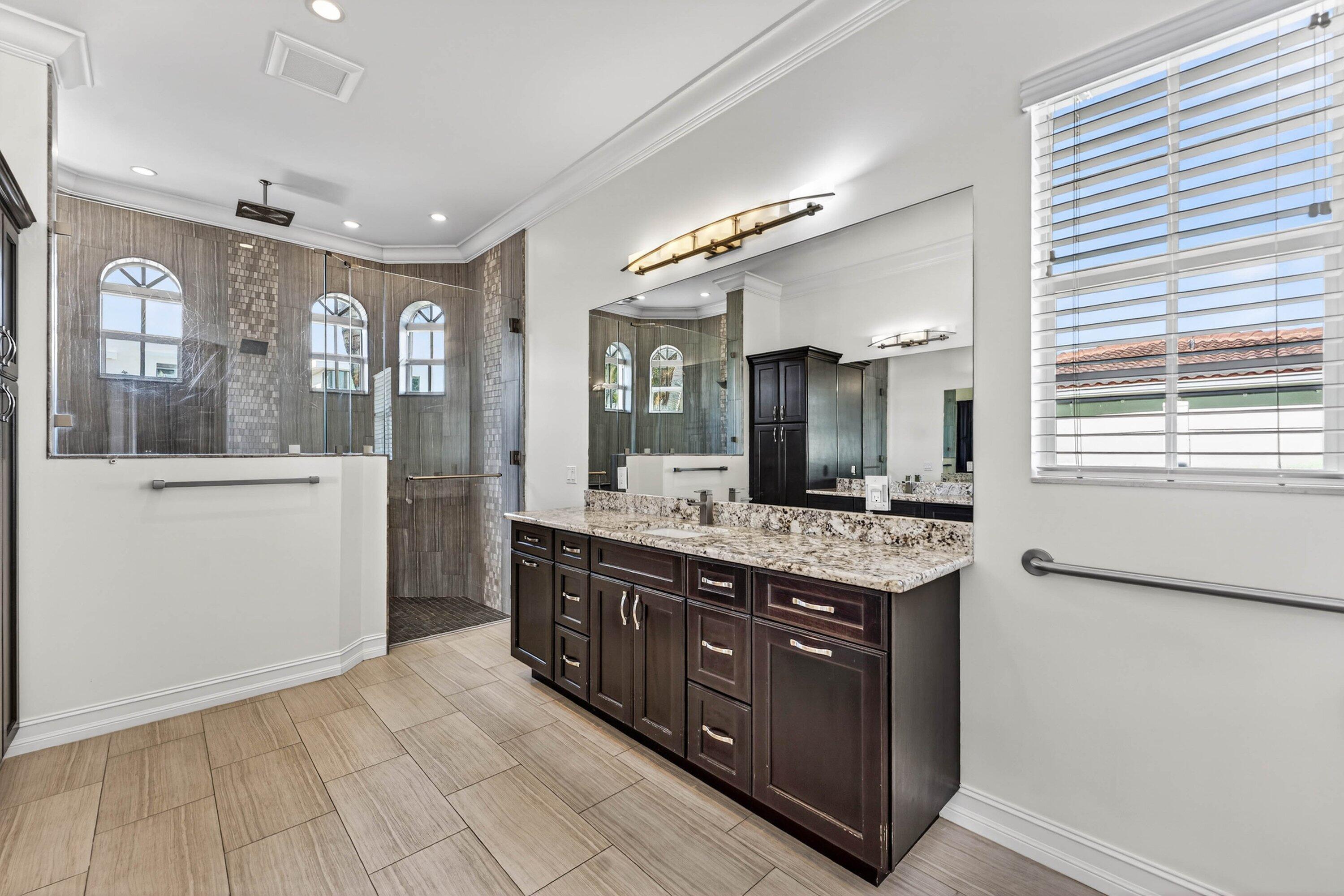 2920 Spanish River Road Boca Raton, FL 33432 - Photo 35 of 75 a spacious bathroom with a granite countertop sink a mirror and a shower