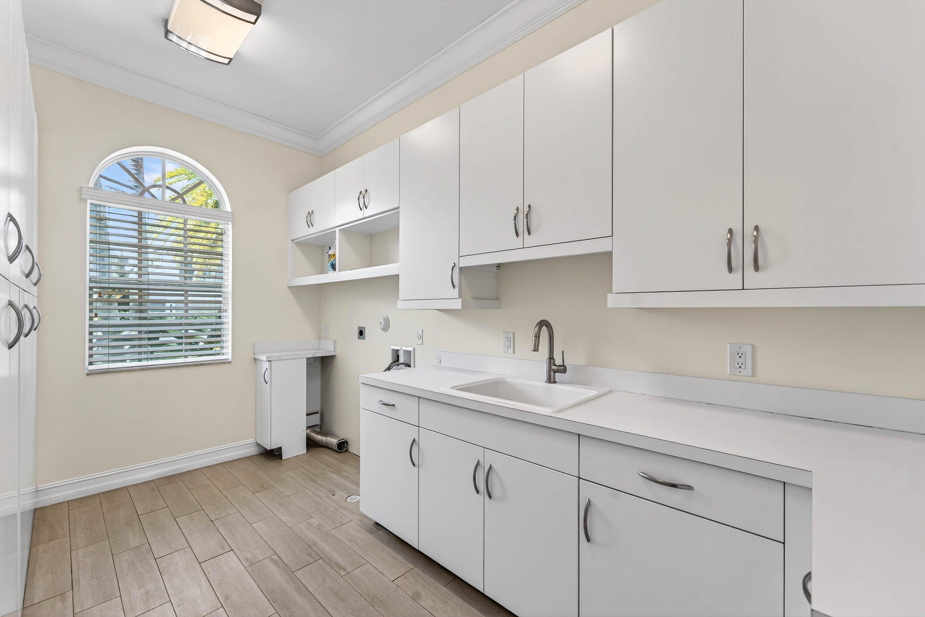 2920 Spanish River Road Boca Raton, FL 33432 - Photo 37 of 75 a kitchen with stainless steel appliances granite countertop a sink and dishwasher with white cabinets