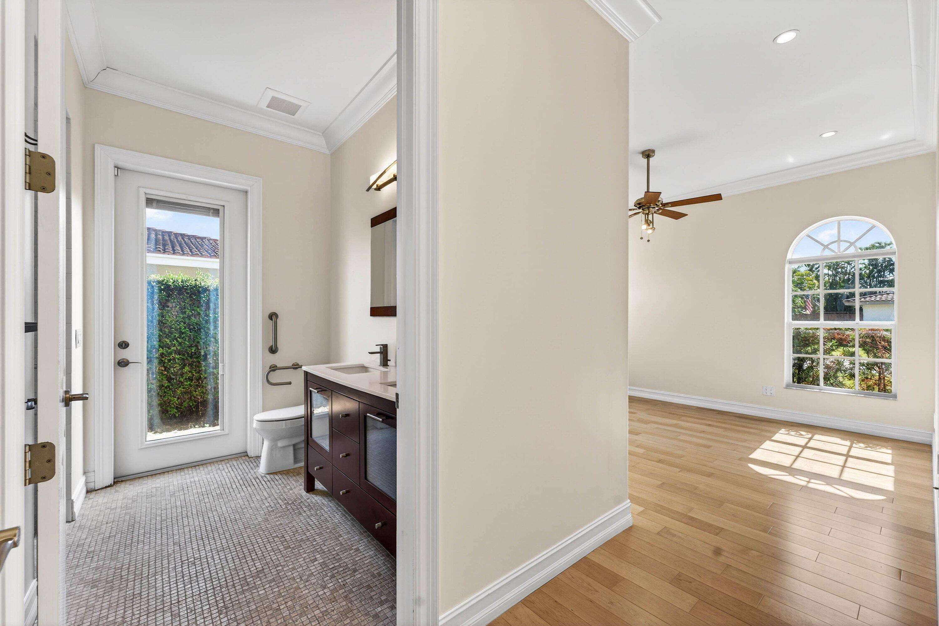 2920 Spanish River Road Boca Raton, FL 33432 - Photo 38 of 75 a view of a hallway with wooden floor and a kitchen