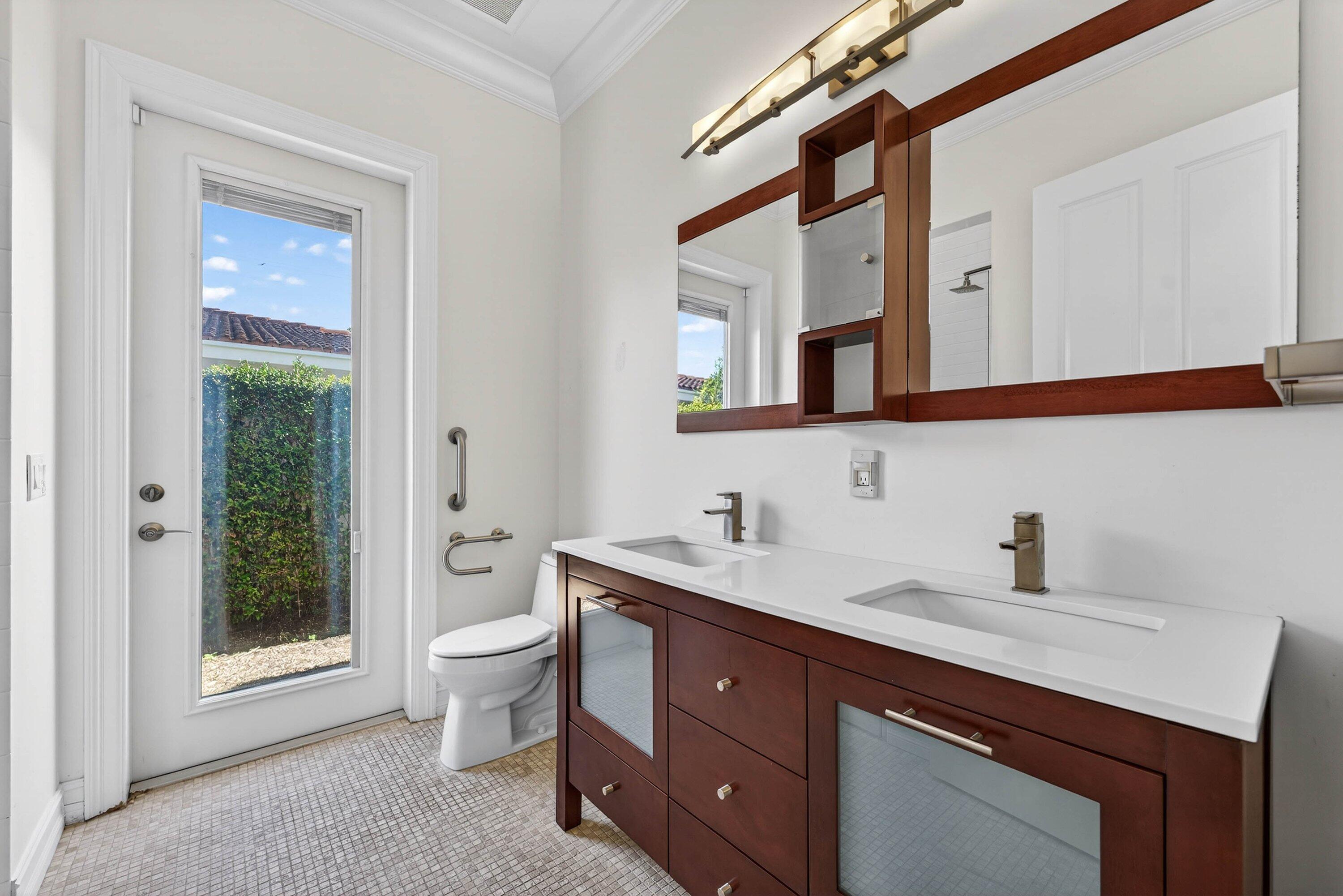 2920 Spanish River Road Boca Raton, FL 33432 - Photo 41 of 75 a bathroom with a toilet sink and mirror