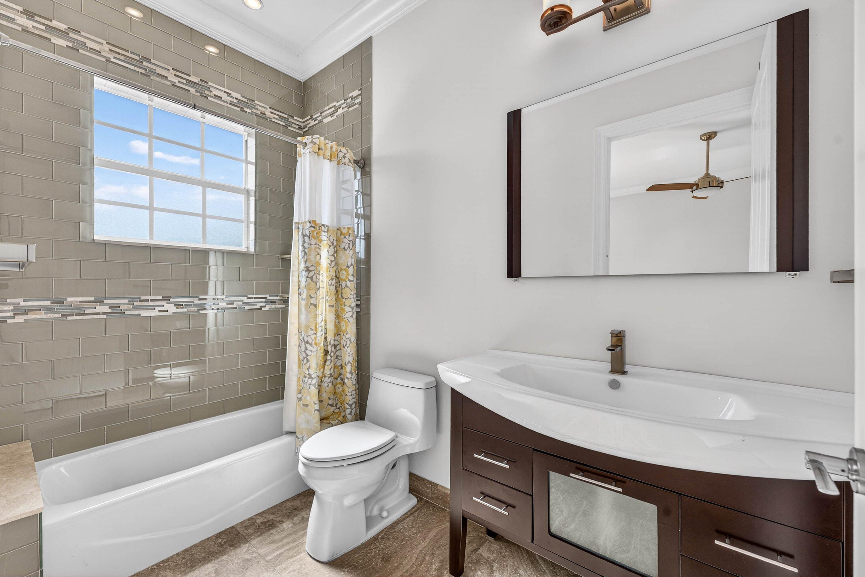 2920 Spanish River Road Boca Raton, FL 33432 - Photo 46 of 75 a bathroom with a sink toilet a mirror and shower