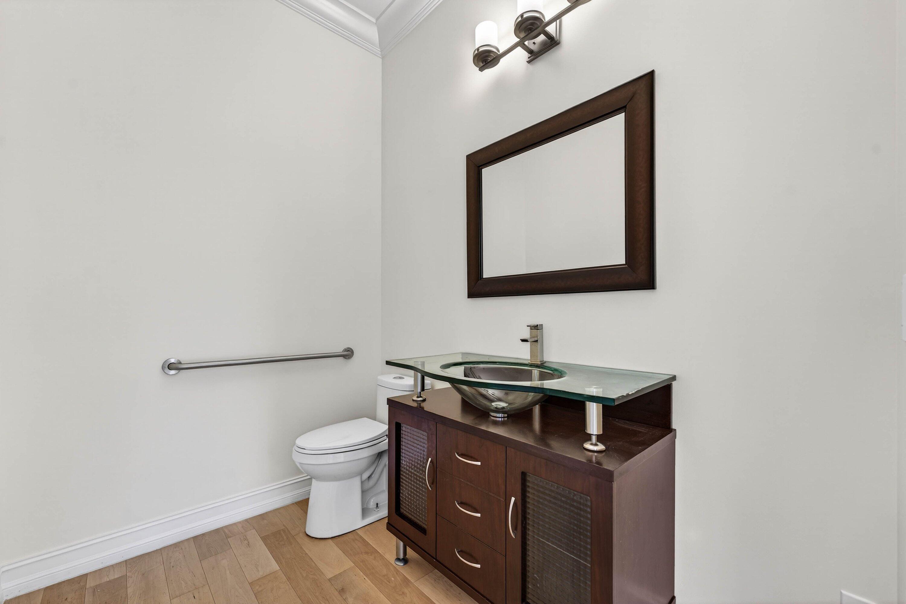 2920 Spanish River Road Boca Raton, FL 33432 - Photo 47 of 75 a bathroom with a toilet sink and mirror