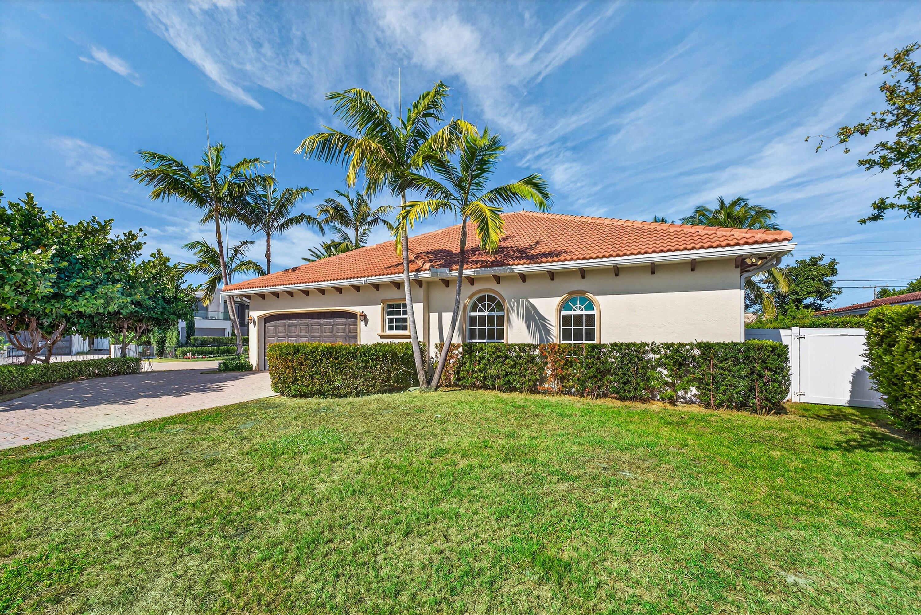 2920 Spanish River Road Boca Raton, FL 33432 - Photo 7 of 75 a front view of a house with a yard and potted plants