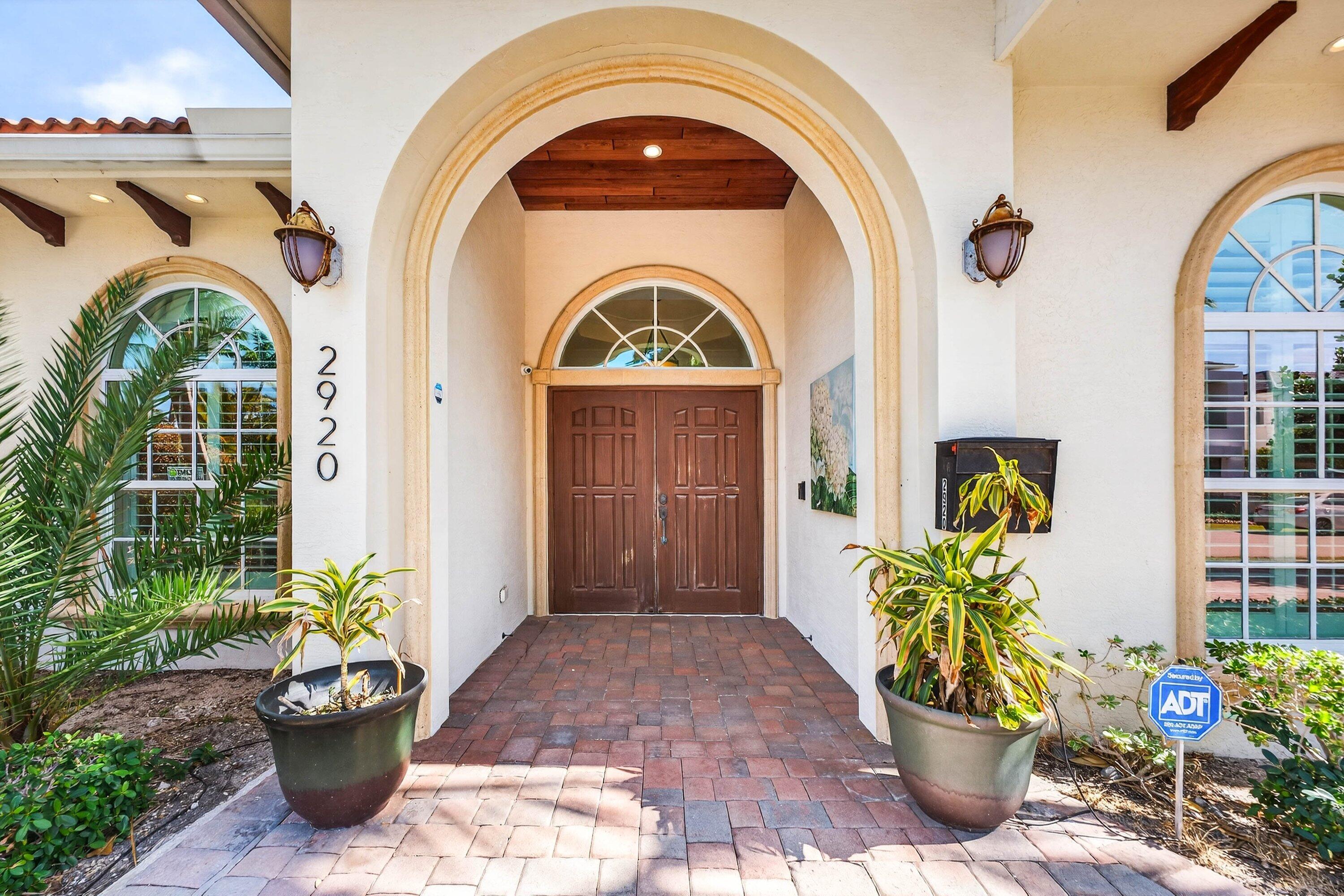 2920 Spanish River Road Boca Raton, FL 33432 - Photo 9 of 75 a front view of a house with outdoor seating