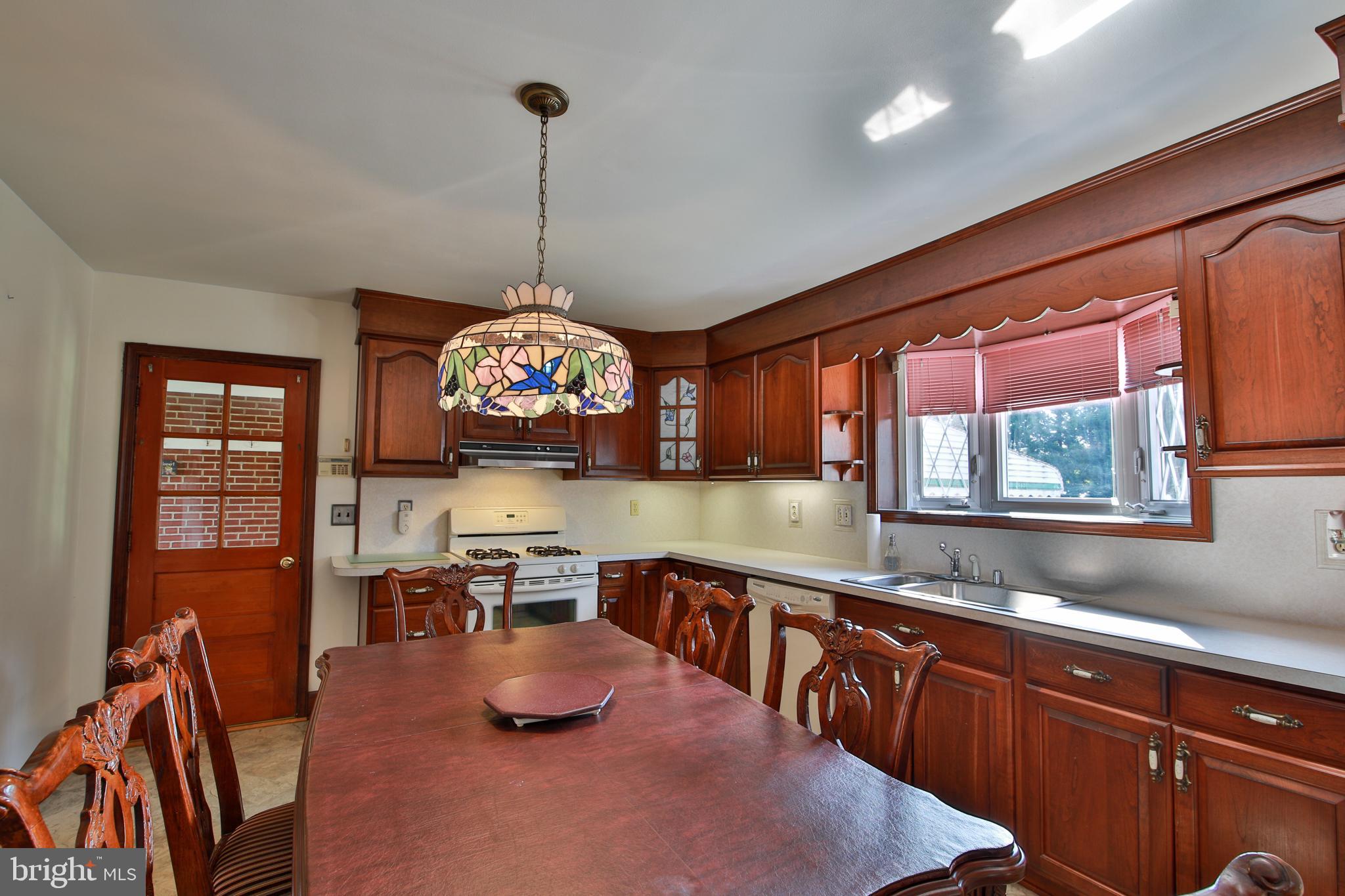 9922 Philadelphia Road Baltimore, MD 21237 - Photo 9 of 44 Kitchen with cherry cabinets.