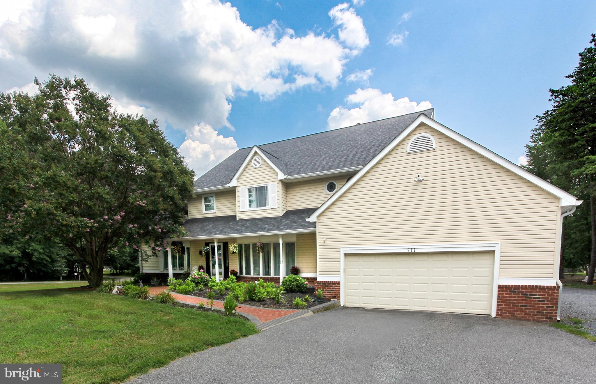 911 South Wieker Road Severn, MD 21144 - Photo 1 of 73 a front view of a house with a garden and trees