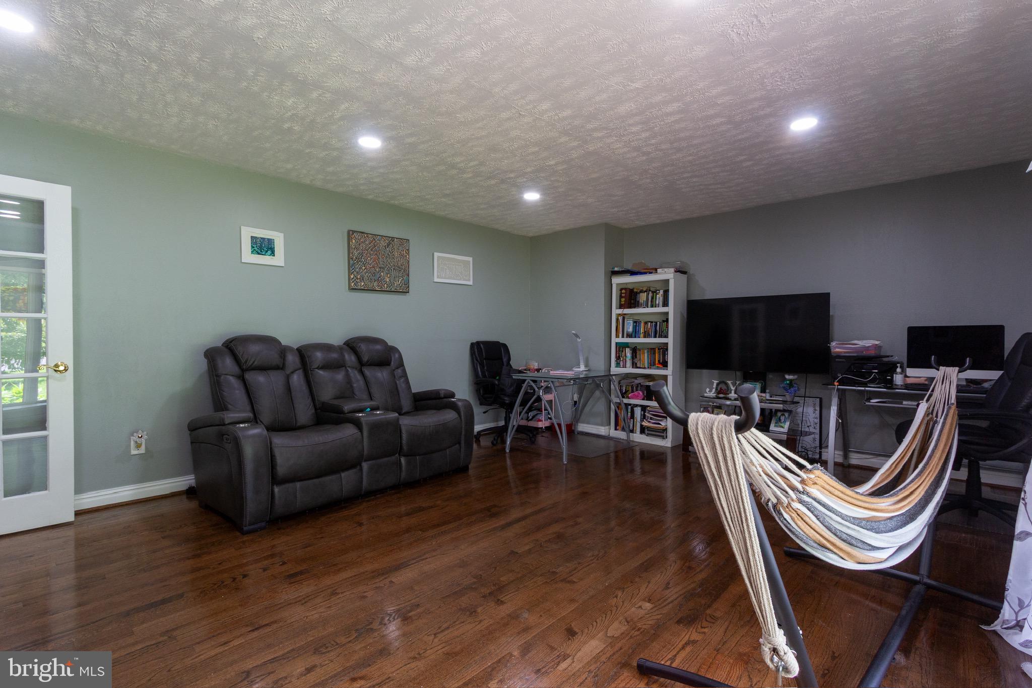 911 South Wieker Road Severn, MD 21144 - Photo 24 of 73 a living room with furniture a flat screen tv and a fireplace