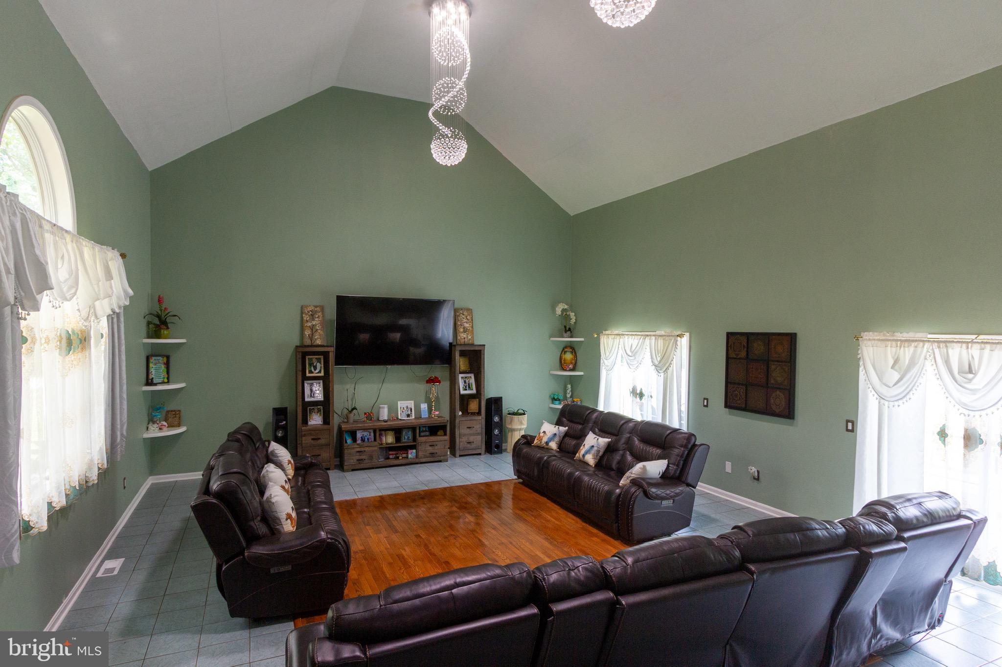 911 South Wieker Road Severn, MD 21144 - Photo 26 of 73 a living room with furniture and a flat screen tv